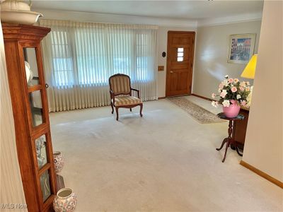 Carpeted entryway with crown molding | Image 2