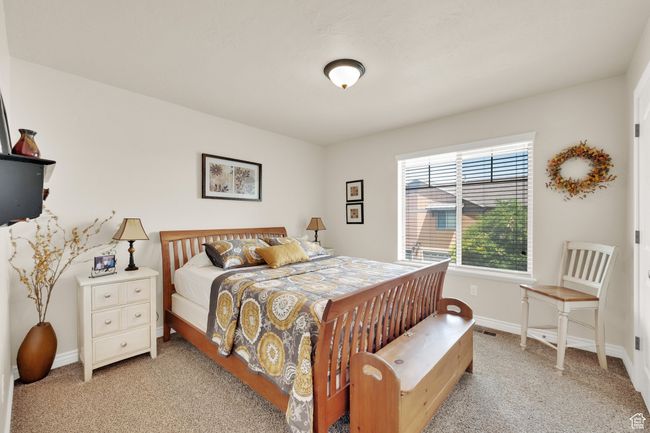 Bedroom with light carpet and baseboards | Image 18