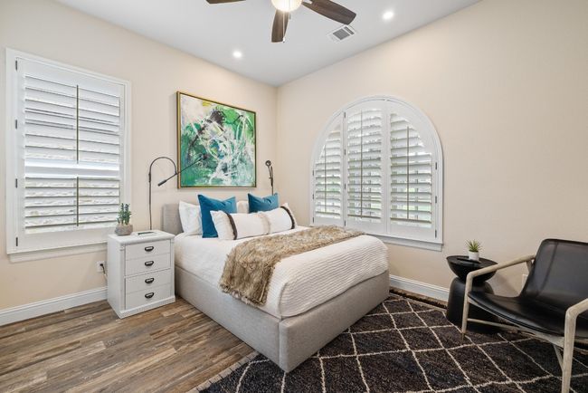 Bedroom featuring wood finished floors, baseboards, multiple windows, and recessed lighting | Image 21