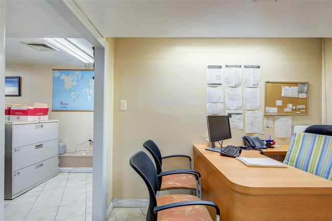 Office space featuring light tile patterned floors and baseboards | Image 8
