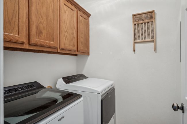 Laundry room with cabinet space and washer and clothes dryer | Image 13