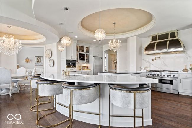 The gourmet kitchen features updated cabinetry, quartz countertops and gorgeous hardwood floors! | Image 15