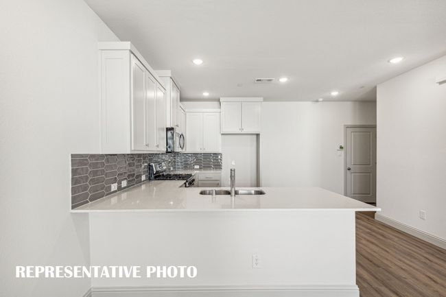 The kitchen peninsula, featuring a breakfast bar, is the perfect place for a quick meal or homework station. REPRESENTATIVE PHOTO | Image 7
