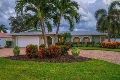 Front of the home with a circular paver driveway. | Image 2