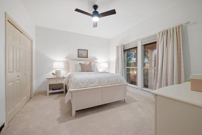 Bedroom featuring light colored carpet, ceiling fan, and a closet | Image 23