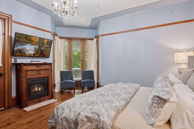Primary bedroom with gas fireplace and access to upper porch | Image 28