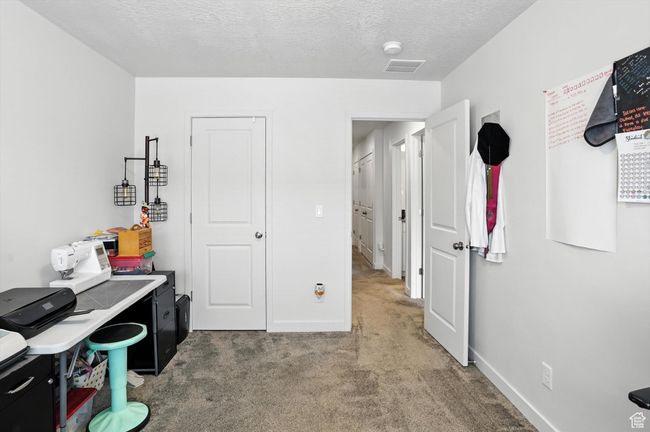 Bedroom used as office space featuring carpet floors and a textured ceiling | Image 39
