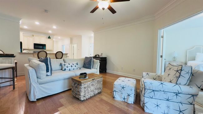 Living room featuring a ceiling fan, ornamental molding, wood finished floors, and recessed lighting | Image 22
