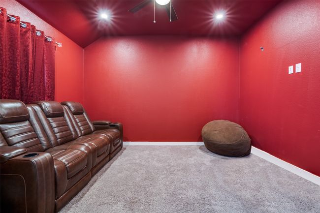 Home theater featuring ceiling fan, carpet flooring, vaulted ceiling, and recessed lighting | Image 20