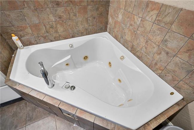 Bathroom featuring tiled bath | Image 29