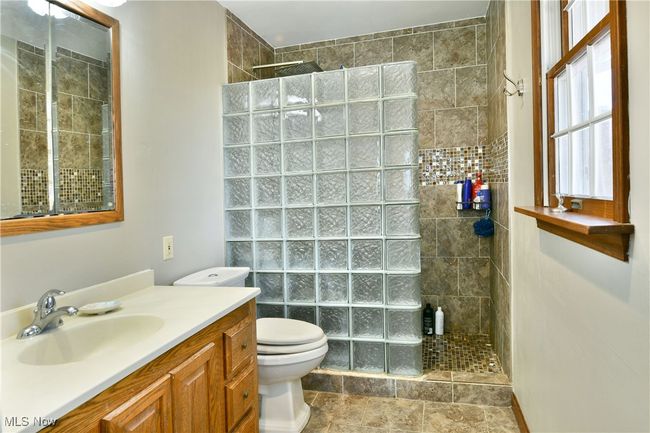 Bathroom with vanity, toilet, and walk in shower | Image 44
