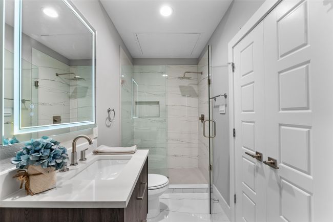 Bathroom featuring vanity, toilet, marble finish floor, a marble finish shower, and recessed lighting | Image 15