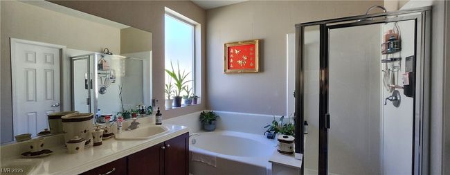 Full bathroom with a shower stall, a bath, and double vanity | Image 5