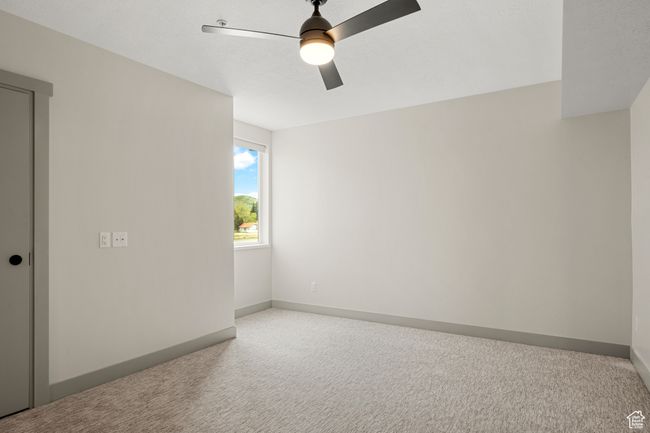 Spare room featuring carpet floors, ceiling fan, and baseboards | Image 23