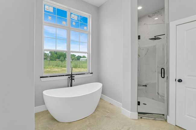 Bathroom with baseboards, a marble finish shower, and healthy amount of natural light | Image 25