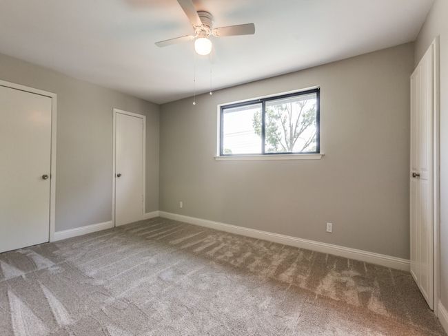 Unfurnished bedroom with carpet, baseboards, and ceiling fan | Image 17