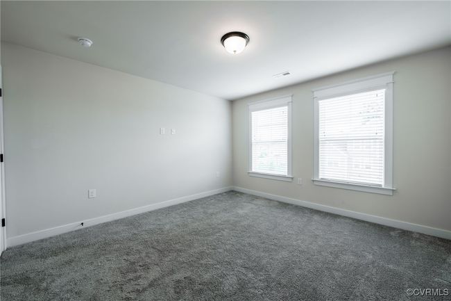 Carpeted empty room with baseboards and a smoke detector | Image 30