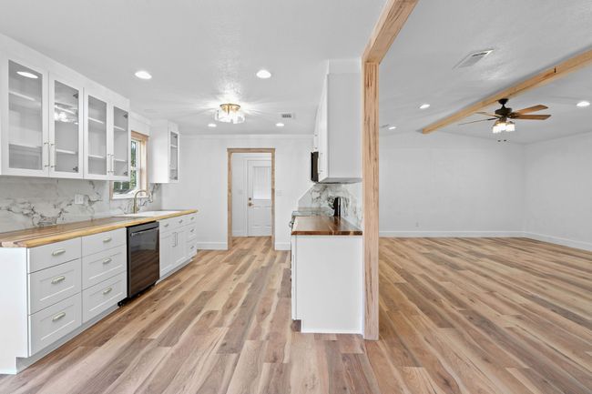 Kitchen featuring tasteful backsplash, visible vents, a sink, appliances with stainless steel finishes, and wood counters | Image 19