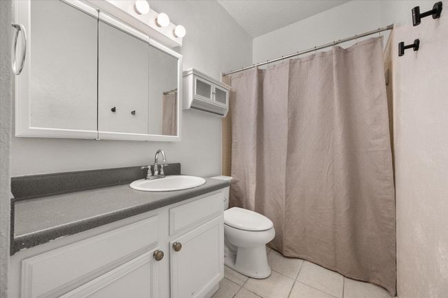 Full bath featuring vanity, tile patterned floors, and a shower with shower curtain | Image 22