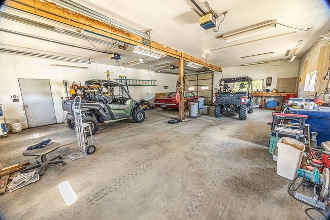Garage featuring a workshop area and a garage door opener | Image 16