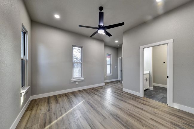 Spare room featuring ceiling fan and hardwood / wood-style flooring | Image 23