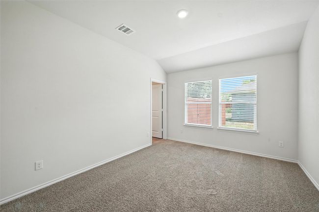 Spare room with vaulted ceiling and light carpet | Image 12