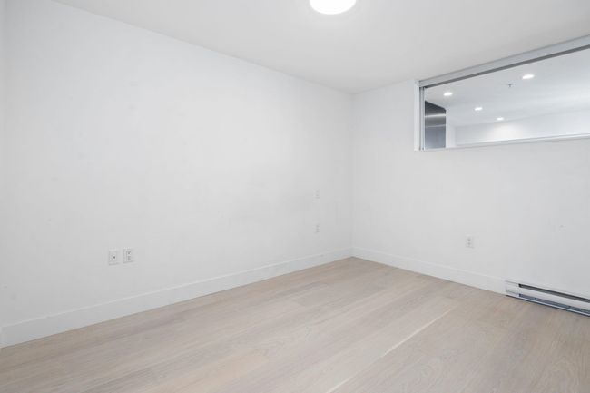 Spare room with baseboards, wood finished floors, recessed lighting, and baseboard heating | Image 14