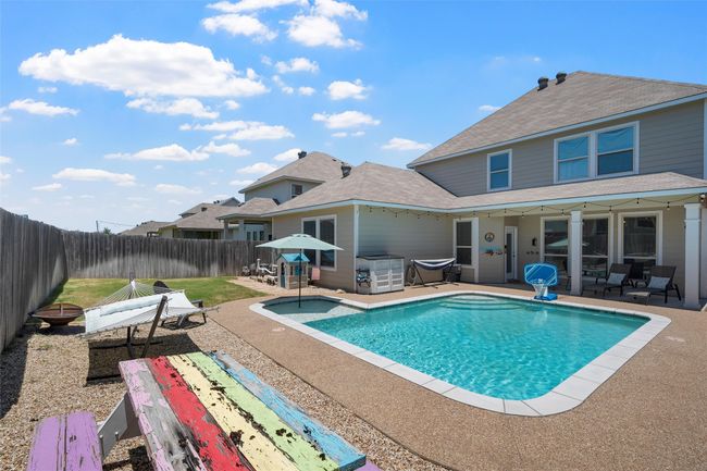 View of swimming pool featuring a patio area and a fenced backyard | Image 34