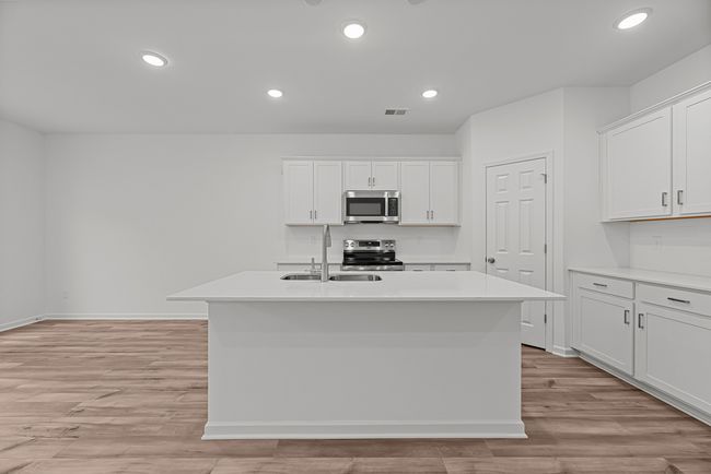 The kitchen has a huge corner pantry- you will be shocked by how much storage is in there! | Image 11