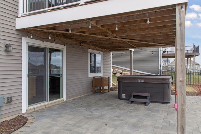 Huge paver patio under the deck, accessable from the bar / family room | Image 40