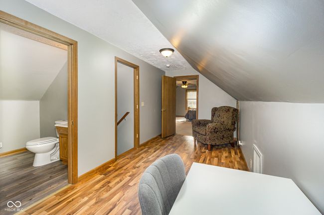 office space featuring baseboards, lofted ceiling, and wood finished floors | Image 17
