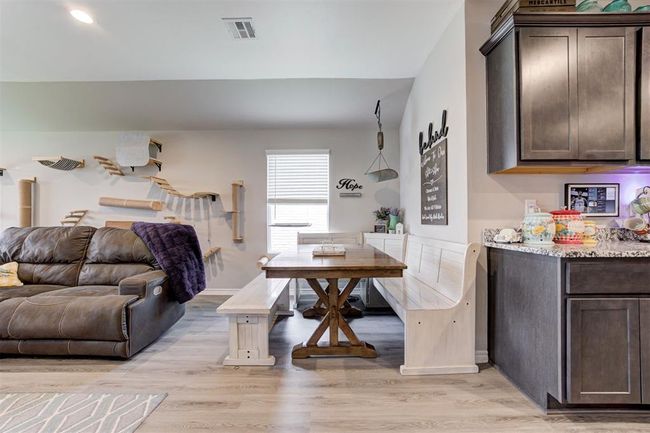 Living room featuring light wood-type flooring and baseboards | Image 11