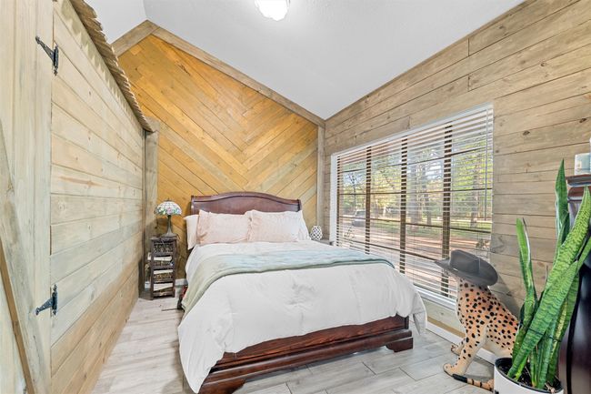Bedroom featuring wood walls and wood finished floors | Image 27