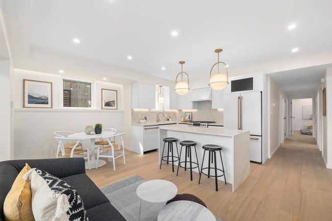 Living room with baseboards, light wood finished floors, and recessed lighting | Image 5