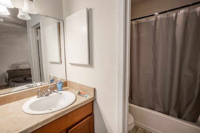 Bathroom featuring vanity and shower / bath combo | Image 11