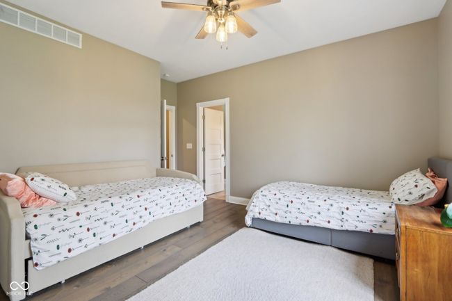 bedroom featuring baseboards, visible vents, wood finished floors, and a ceiling fan | Image 36