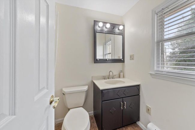 bathroom featuring baseboards, toilet, and vanity | Image 18