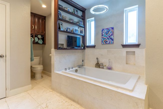 Bathroom with toilet and a bath | Image 15