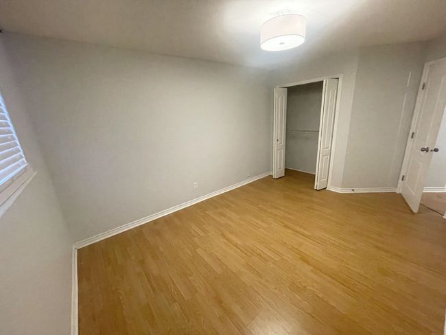 Unfurnished bedroom with light wood-style flooring, a closet, and baseboards | Image 38