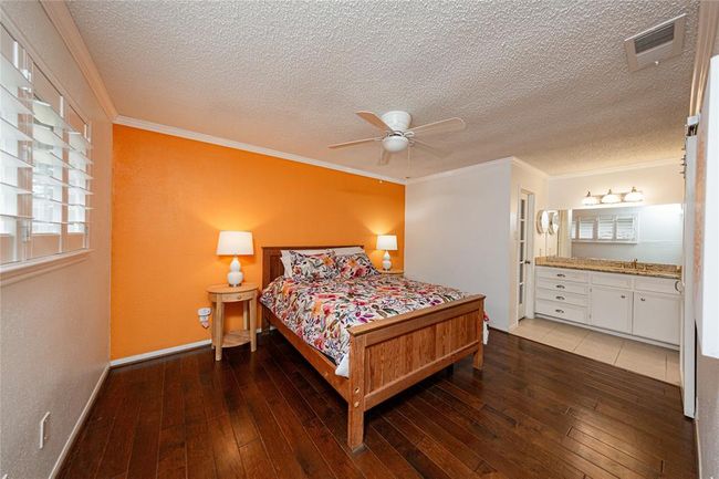 Your primary bedroom is at the front of the home and includes plantation shutters | Image 12
