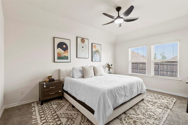 Bedroom with light carpet, baseboards, and ceiling fan | Image 20