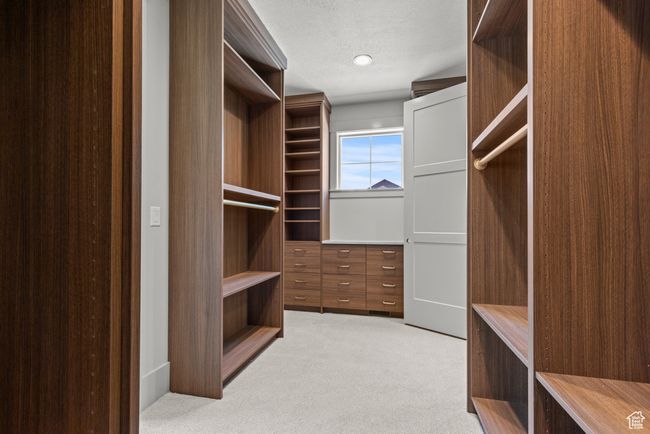 Walk in closet featuring light carpet | Image 21
