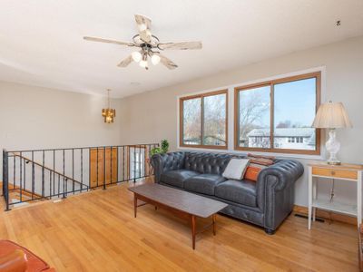 Large windows fill the living spaces with natural light, showcasing gleaming hardwood floors freshly painted walls. | Image 3