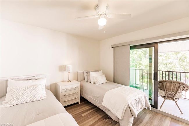 Bedroom with wood finished floors, access to exterior, and a ceiling fan | Image 19