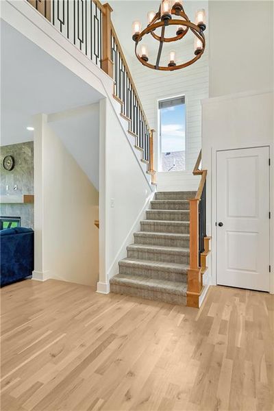 Stairway featuring high-traffic carpet, shiplap, and a high ceiling | Image 3