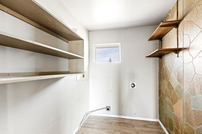 Laundry area with electric dryer hookup, wood finished floors, laundry area, and baseboards | Image 19