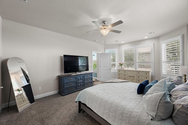 Bedroom with carpet, multiple windows, and ceiling fan | Image 21