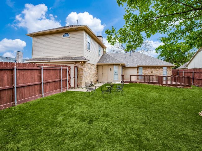 Back of property featuring brick siding, roof with shingles, and a chimney | Image 20