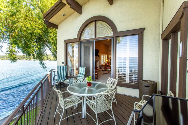Deck featuring a water view and outdoor dining area | Image 13