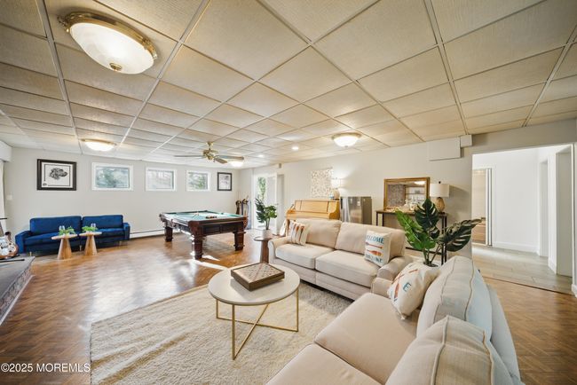 1st floor spacious living room with hw floors, fireplace, kitchenette nearby with sliders to level yard | Image 35